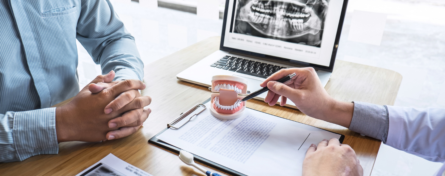 Provider points at mouth, showing something to patient