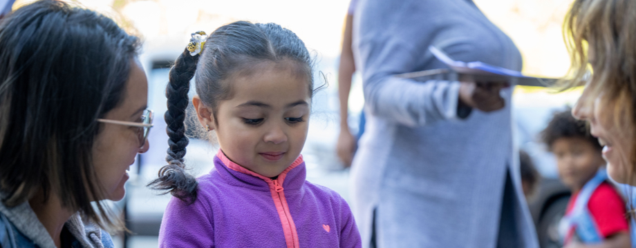 Girl in a park with adults