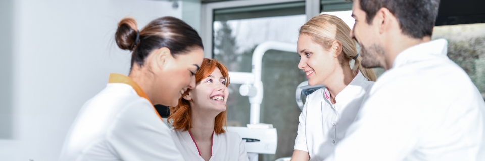 Group of providers smiling, standing by equipment